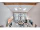Bright living room featuring large windows, a fireplace, and vaulted ceilings with skylights at 5603 S Pagosa Ct, Centennial, CO 80015