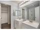 Double vanity bathroom featuring modern fixtures, lighting and walk-in closet at 8777 E Dry Creek Rd # 1426, Englewood, CO 80112