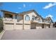 Charming townhome exterior with attached garages and well-maintained landscaping under a bright blue sky at 8777 E Dry Creek Rd # 1426, Englewood, CO 80112