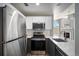Well-equipped kitchen featuring stainless steel appliances, white cabinets, and contemporary finishes at 8777 E Dry Creek Rd # 1426, Englewood, CO 80112