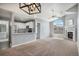 Inviting living room featuring modern lighting, fireplace, and seamless flow into a kitchen with stainless steel appliances at 8777 E Dry Creek Rd # 1426, Englewood, CO 80112