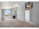 Bright and spacious living room featuring vaulted ceiling, fireplace, and large arched window at 8777 E Dry Creek Rd # 1426, Englewood, CO 80112