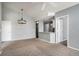 Open concept living room showcasing modern lighting and bar, seamlessly connecting to a kitchen at 8777 E Dry Creek Rd # 1426, Englewood, CO 80112