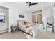 Bright bedroom featuring a modern ceiling fan, a large window and a stylish ensuite bathroom at 1232 N Yates St # 3, Denver, CO 80204