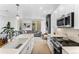 Well-lit kitchen with white cabinets, stainless steel appliances, and an open view to the living area at 1232 N Yates St # 3, Denver, CO 80204