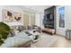 Comfortable living room with a large gray couch, decorative fireplace, and abundant natural light at 1232 N Yates St # 3, Denver, CO 80204