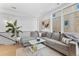 Cozy living room with large windows, a comfortable gray couch, and modern decor at 1232 N Yates St # 3, Denver, CO 80204