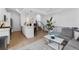 Open living area featuring a modern kitchen with white cabinetry and an adjacent living room at 1232 N Yates St # 3, Denver, CO 80204