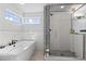 Modern bathroom with a soaking tub, glass shower, and stylish fixtures for a luxurious feel at 128 Chapel Hill Cir, Brighton, CO 80601