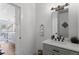 Well-lit bathroom featuring a modern vanity, mirror, and neutral decor at 128 Chapel Hill Cir, Brighton, CO 80601