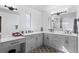 Bathroom with gray cabinetry, modern mirrors, and a clean design for a serene experience at 128 Chapel Hill Cir, Brighton, CO 80601