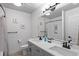 Bathroom featuring double sinks, modern fixtures, and a tiled shower, offering a luxurious and functional space at 128 Chapel Hill Cir, Brighton, CO 80601