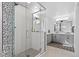 Modern bathroom featuring a glass shower with custom mosaic tile and double vanity sinks at 128 Chapel Hill Cir, Brighton, CO 80601