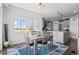 Bright dining area with a modern table and a view of the updated kitchen at 128 Chapel Hill Cir, Brighton, CO 80601