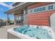 Private backyard featuring a relaxing hot tub surrounded by lush landscaping and stylish design at 128 Chapel Hill Cir, Brighton, CO 80601