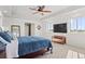 The main bedroom with modern tray ceilings boasts abundant natural light and an en suite bathroom at 128 Chapel Hill Cir, Brighton, CO 80601