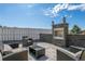 Cozy outdoor fireplace with comfortable seating, creating an inviting ambiance for outdoor gatherings at 128 Chapel Hill Cir, Brighton, CO 80601