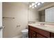 Bathroom with a single sink vanity, bright lighting, tiled shower, and a toilet at 18171 E Arizona Ave # B, Aurora, CO 80017