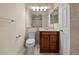 This bathroom features a single sink vanity, bright lighting, and tiled shower at 18171 E Arizona Ave # B, Aurora, CO 80017