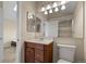 This bathroom features a single sink vanity, bright lighting, and shower and toilet at 18171 E Arizona Ave # B, Aurora, CO 80017