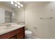 Bathroom featuring a dark wood vanity, a large mirror, a toilet, and a shower and tub combo at 18171 E Arizona Ave # B, Aurora, CO 80017