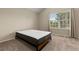 Bedroom featuring neutral carpet, one window with blinds, and a bed frame with an aspen mattress at 18171 E Arizona Ave # B, Aurora, CO 80017