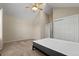 Bright bedroom featuring neutral carpet, one window with blinds, a bed frame, vaulted ceiling, and closet at 18171 E Arizona Ave # B, Aurora, CO 80017