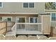 View of wooden deck with white railing; sliders provide backyard access at 18171 E Arizona Ave # B, Aurora, CO 80017