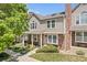 Charming two-story townhome with a brick chimney, well-manicured lawn and inviting front porch at 18171 E Arizona Ave # B, Aurora, CO 80017