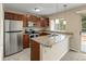 The kitchen features wood cabinets, stainless steel appliances, and granite countertops at 18171 E Arizona Ave # B, Aurora, CO 80017