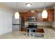 This kitchen has stainless appliances and granite countertops and a serving bar at 18171 E Arizona Ave # B, Aurora, CO 80017