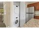 The kitchen includes a stacked washer/dryer along with stainless appliances and granite counters at 18171 E Arizona Ave # B, Aurora, CO 80017