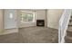 Cozy living room with carpet, natural light, a fireplace, and staircase at 18171 E Arizona Ave # B, Aurora, CO 80017