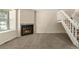 Cozy living room with carpet, natural light, a fireplace, and staircase at 18171 E Arizona Ave # B, Aurora, CO 80017