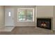 Cozy living room with carpet, natural light, and a fireplace with a granite hearth at 18171 E Arizona Ave # B, Aurora, CO 80017