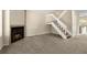 Cozy living room with carpet, natural light, a fireplace, and staircase at 18171 E Arizona Ave # B, Aurora, CO 80017