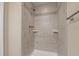 Tiled shower with a decorative tile border and two built-in shelves at 18171 E Arizona Ave # B, Aurora, CO 80017