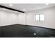 Finished basement room with dark gray flooring and large window at 3120 Braun Ct, Golden, CO 80401