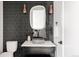 Stylish bathroom featuring dark tile, a unique vessel sink, and black accents at 3120 Braun Ct, Golden, CO 80401