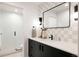 Modern bathroom with checkered tile, sleek vanity, and glass shower at 3120 Braun Ct, Golden, CO 80401