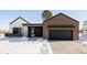 Modern home exterior with brick and white siding, plus a black garage door at 3120 Braun Ct, Golden, CO 80401