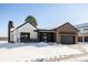Stunning modern farmhouse exterior with brick and white siding, snowy landscape at 3120 Braun Ct, Golden, CO 80401