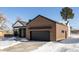 View of modern home's exterior showcasing brick, white siding and a black garage door at 3120 Braun Ct, Golden, CO 80401