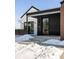 Modern front entrance with black siding, glass door and concrete steps at 3120 Braun Ct, Golden, CO 80401