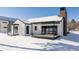 Back of house with white siding, large deck, and snowy yard at 3120 Braun Ct, Golden, CO 80401