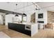 Modern kitchen with large island, dark cabinetry, and open floor plan at 3120 Braun Ct, Golden, CO 80401