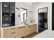 Modern kitchen with light wood cabinets, white countertops, and black accents at 3120 Braun Ct, Golden, CO 80401