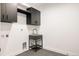 Modern laundry room with dark cabinetry and a stylish utility sink at 3120 Braun Ct, Golden, CO 80401