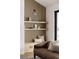 Built-in shelving with wood paneling accents in a living room at 3120 Braun Ct, Golden, CO 80401