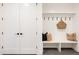 Functional mudroom with white shiplap, built-in bench, and storage at 3120 Braun Ct, Golden, CO 80401
